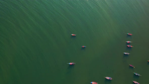 Many fishing boats on the coast beside the mountains, beautiful sea area in Thailand.