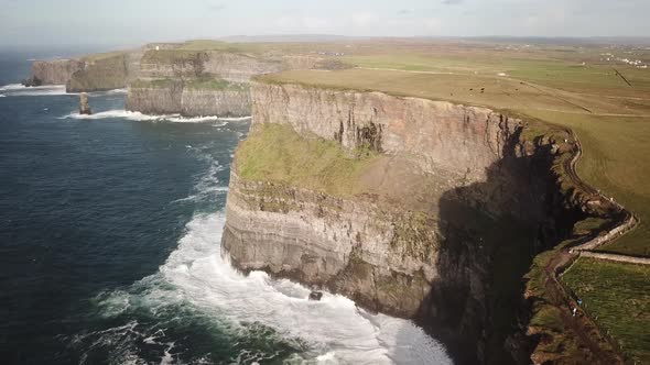 Cliffs of moher, Ireland and their huge height compared to the atlantic ocean, drone aerial shot