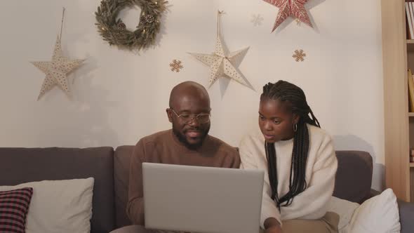 Black Couple Using Laptop at Christmas