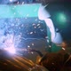Welder in Welding Mask in Working Clothes at the Factory Welds the Pipe in the Factory Room - VideoHive Item for Sale