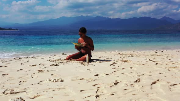 Tourists relaxing on luxury seashore beach break by turquoise sea and white sandy background of Bali