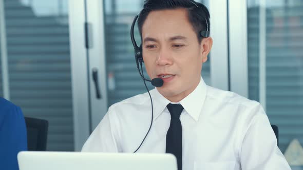 Businessman Wearing Headset Working Actively in Office