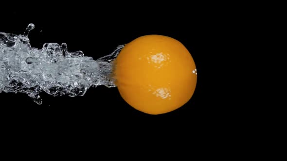 Fresh Ripe Orange is Bouncing From the Water with Drops and Splashes