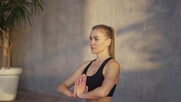 Female Coach Yoga Makes Namaste Gesture By Hands Indoors in the Morning