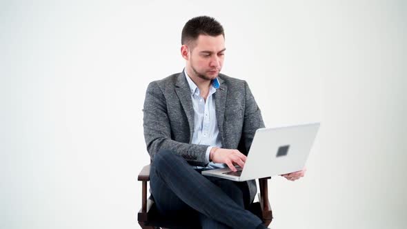Portrait of serious businessman with a laptop