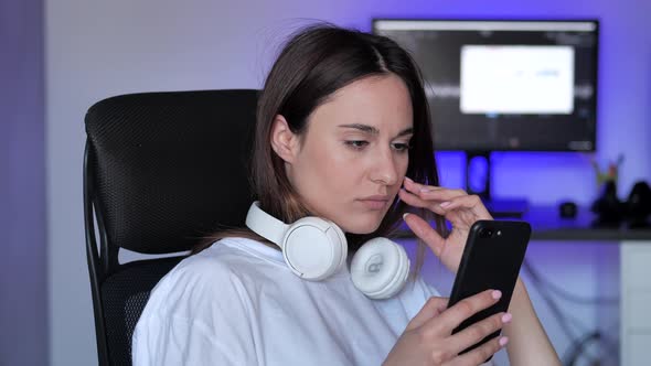 Worried Young Woman Reading Bad News in Message on Smartphone