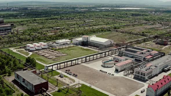 Aerial Wide View Over Oil Refinery or Chemical Factory with Many Storage Tanks and Pipelines