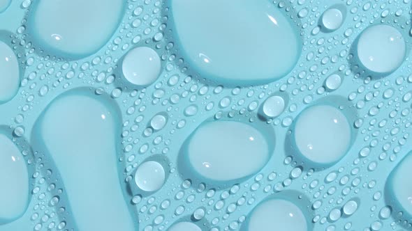 Macro Shot of Cosmetic Moisturizing Drops of Liquid on a Greenblue Pastel Background