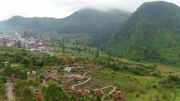 Outskirts of Wonosobo city, Java, misty mountains and farmland aerial view