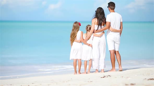 Happy Beautiful Family on White Beach