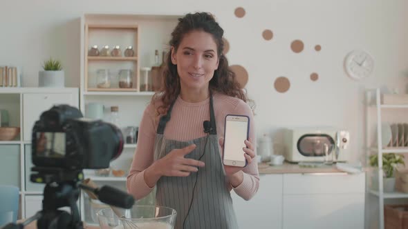 Woman Showing Recommendations on Smartphone
