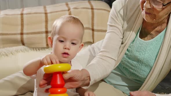 Elderly Grandmother Playing with Baby Grandson