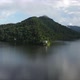 Hilly forested coast of lake under clouds - VideoHive Item for Sale