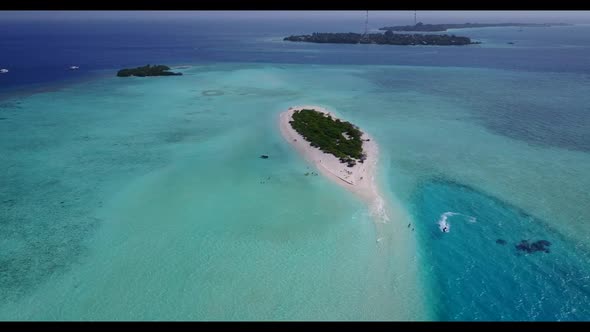 Aerial flying over texture of tranquil bay beach trip by turquoise ocean and white sand background o