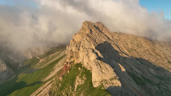 Sunrise in the Dolomites mountains with fog and mist