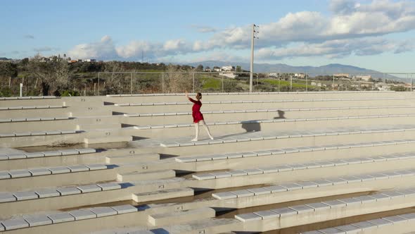 Girl dances in an outdoor theater