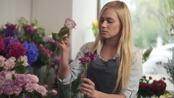 Young Female Florist Business Owner Working and Preparing Flower Arrangements in Her Shop with Fresh