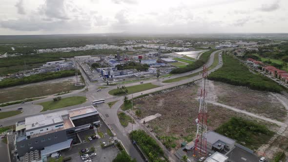 Aerial Beside Radio Mast Tower Beside CEPM Electric Plant And Traffic Going Past On Carretera Higuey