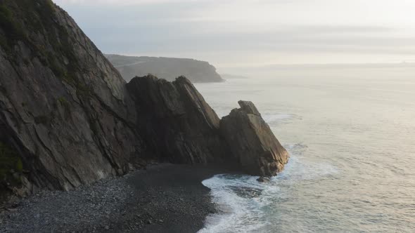 Aerial View of the Picturesque High Coastline Sharp Cliffs and Raging Sea