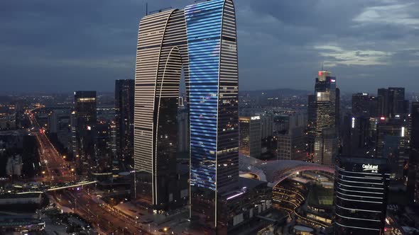 Aerial of CBD buildings by Jinji Lake at night in Suzhou, China.