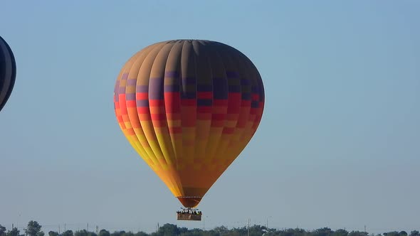 Hot Air Balloon Flying in Still Cloudless Clear Sky