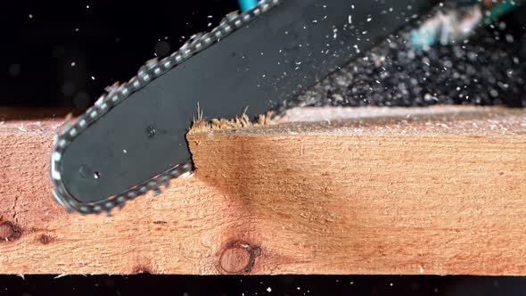 Super Slow Motion Detail Shot of Cutting Wood with Chainsaw at 1000 Fps.