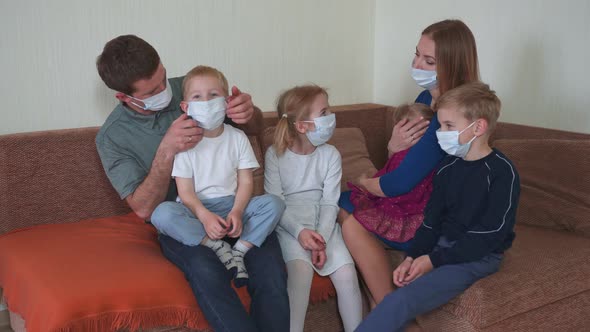 Quarantine Concept. A Large Family of Masks in Their Own Home.