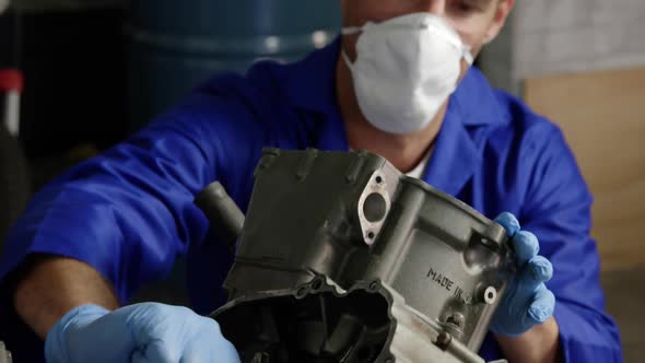 Male mechanic repairing motorbike engine in repair garage 4k