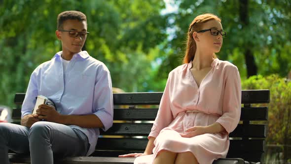 Mixed-Race Student Touching Hand of Girl, Sitting on Bench, First Relations