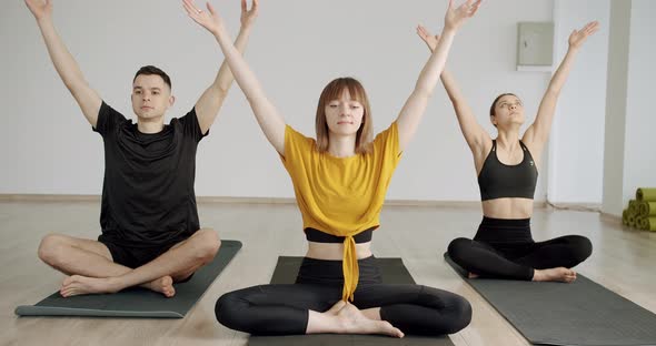 Young Diversity Sporty People Practicing Yoga Lesson with Instructor Namaste