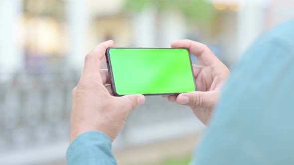 Outdoor Man Looking at Smartphone with Chroma Screen