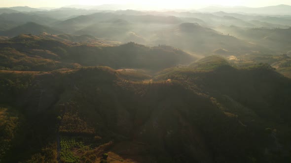 Aerial view of sunrise with fog above mountains