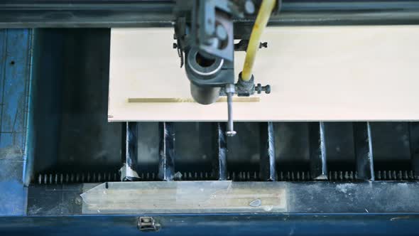 Top view of the working area of a laser engraving machine while burning