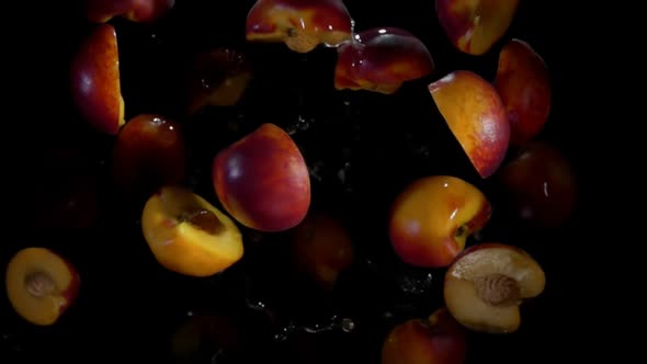 Halves of Peach Fly in Splashes of Water