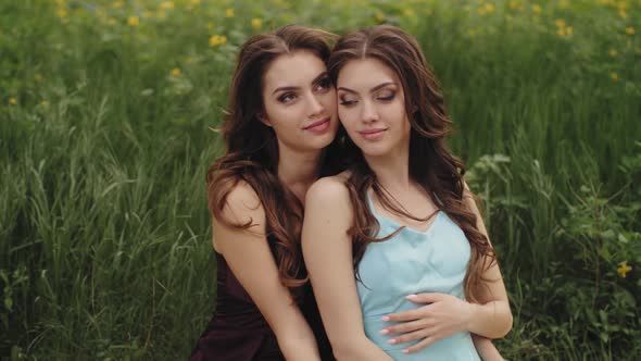 Spring Beauty Portrait of Two Women on the Green Nature Background