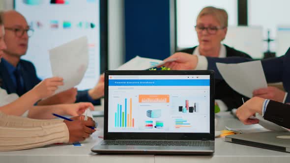 Busy Multicultural Diverse Employees Analysing Annual Financial Statistics