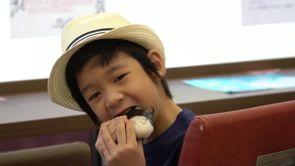 Cute Asian Child Eating Rice Ball Or Onigiri Slow Motion