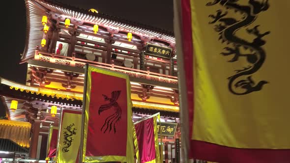 Chinese Pagoda Richly Decorated with Colorful Flags with Images of Dragons