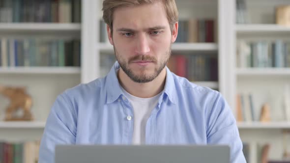 Portrait of Man Reacting to Loss While Using Laptop
