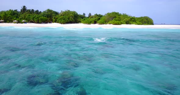 Luxury fly over travel shot of a white sand paradise beach and turquoise sea background in colourful