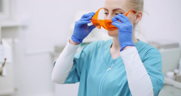 Female Doctor Wearing anti-UV Glasses in Healthcare Clinic