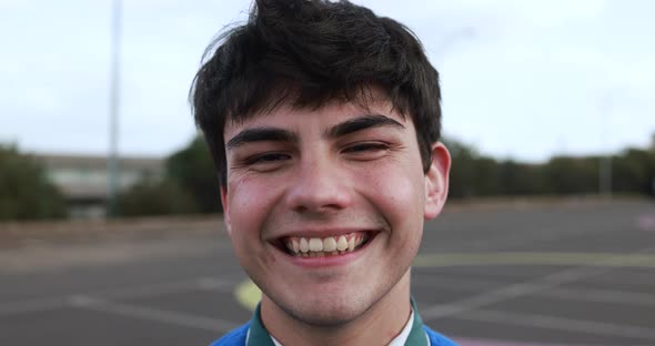 Young man smiling on camera outdoor