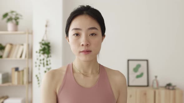 Young Asian Woman Exercising with Dumbbells at Home