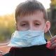 Child Boy Takes Off His Medical Mask Outdoors. - VideoHive Item for Sale