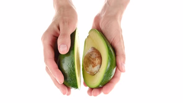 Female hands hold avocado, close up