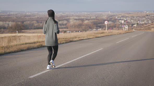 Young Fitness Woman Runner Athlete Running at Road