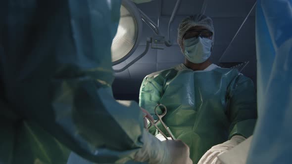 Male Surgeon Concentrated On Work
