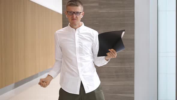 Crazy Happy Businessman Dancing In Corporate Lobby Wearing Airpods