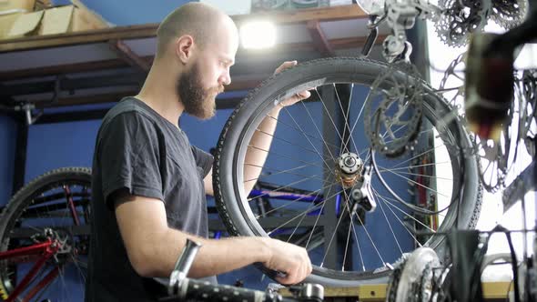 Man repairing a bike wheel