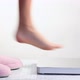 Close up of woman stepping out of slippers and onto scales - VideoHive Item for Sale